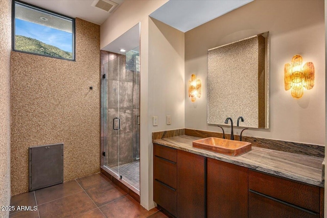 bathroom featuring a shower stall, tile patterned flooring, vanity, and visible vents