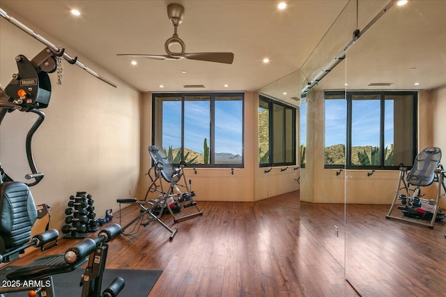 exercise area with wood-type flooring, ceiling fan, and recessed lighting