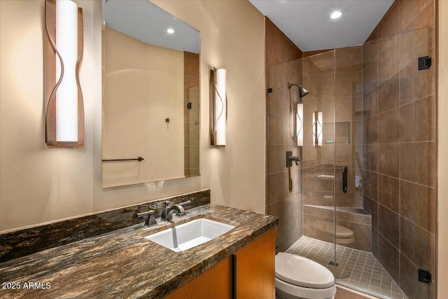 full bathroom featuring toilet, vanity, a shower stall, and recessed lighting