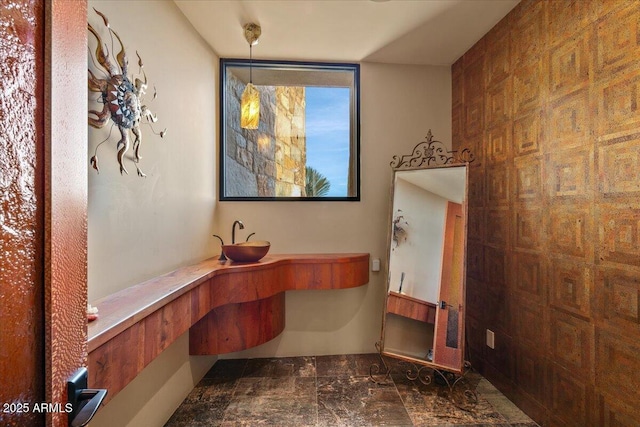 office area featuring a sink and marble finish floor