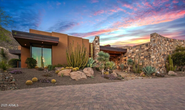 property exterior at dusk with stucco siding