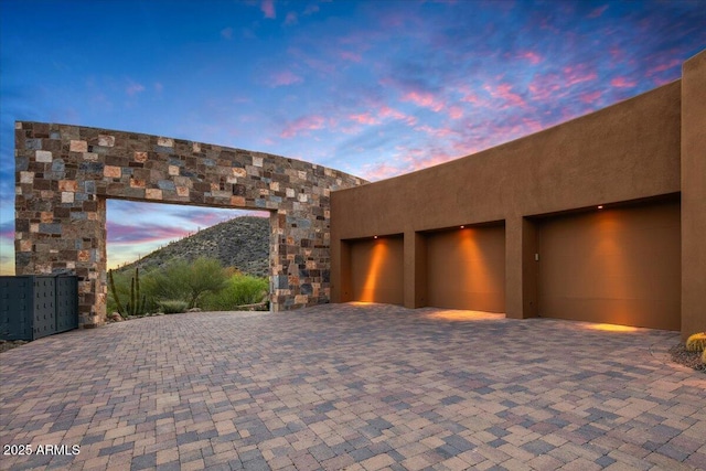 view of garage at dusk