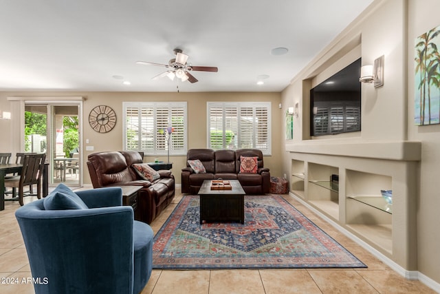 living room with ceiling fan, light tile patterned floors, and built in features