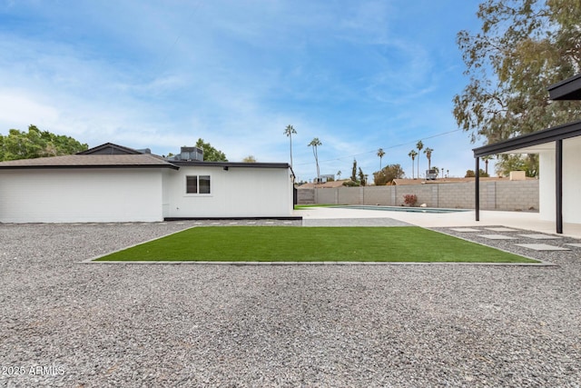 view of yard with a fenced in pool and a patio