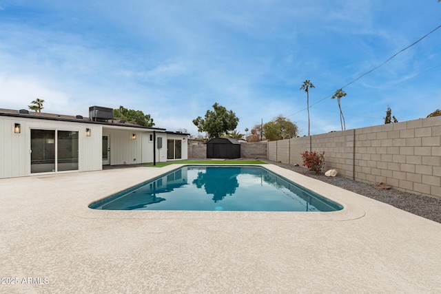 view of pool featuring a shed, a patio area, and central air condition unit