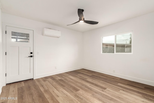 entrance foyer with a wall mounted air conditioner, ceiling fan, and light wood-type flooring