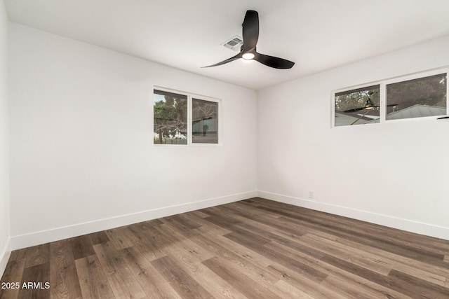 unfurnished room featuring hardwood / wood-style flooring, a wealth of natural light, and ceiling fan