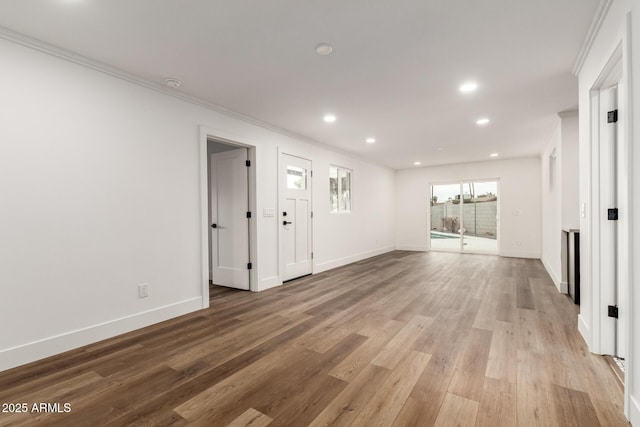 unfurnished room with crown molding and light hardwood / wood-style floors