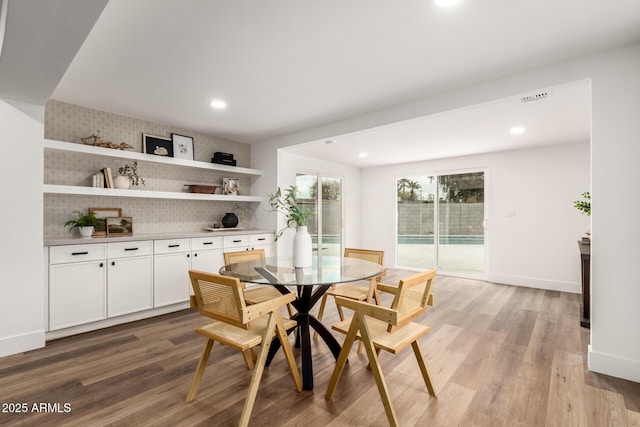 dining area with wood-type flooring