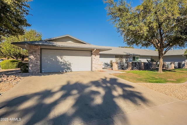 ranch-style home with driveway, a front yard, a garage, and brick siding