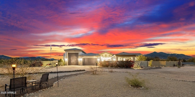 view of front facade featuring a garage and a mountain view