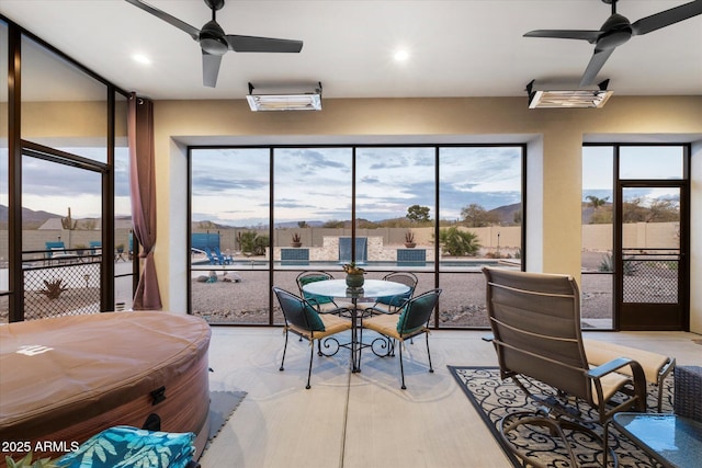 sunroom featuring a healthy amount of sunlight and ceiling fan