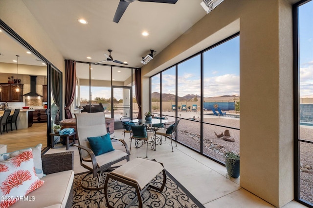 sunroom / solarium with plenty of natural light and ceiling fan