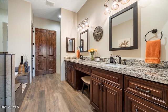 bathroom featuring hardwood / wood-style flooring and vanity