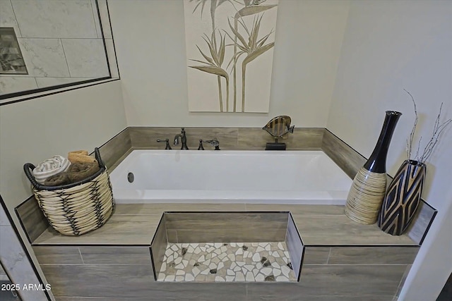 bathroom with tiled tub