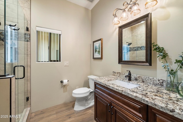 bathroom featuring an enclosed shower, vanity, hardwood / wood-style flooring, and toilet