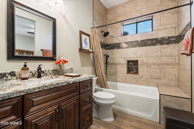 full bathroom with vanity, wood-type flooring, toilet, and shower / bath combo with shower curtain