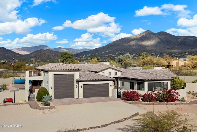 view of front of property featuring a mountain view and a garage