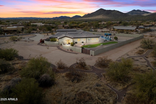 aerial view at dusk featuring a mountain view