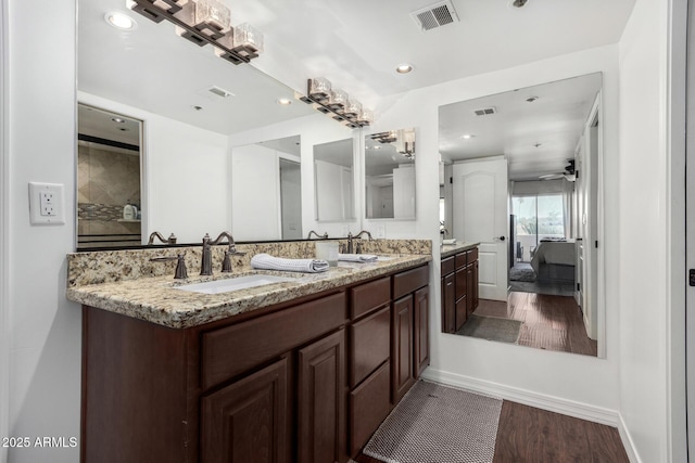 bathroom with vanity, wood-type flooring, and ceiling fan