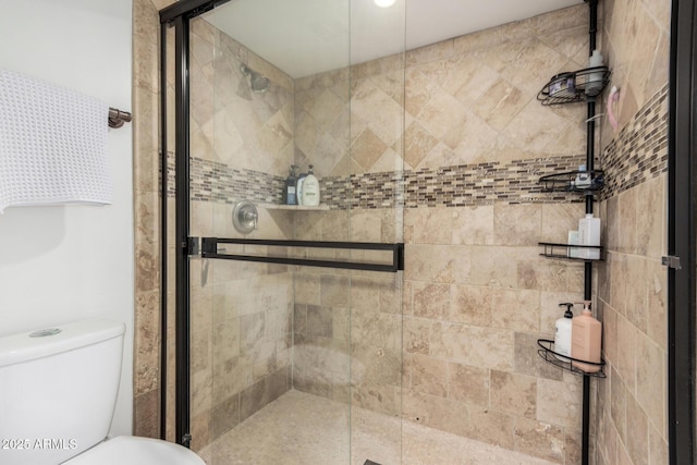 bathroom with an enclosed shower and toilet