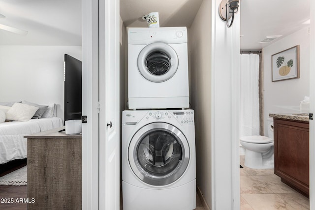 laundry room featuring stacked washer and clothes dryer