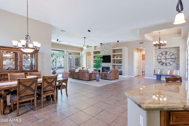 32731 N 74th Way, Scottsdale, AZ 85266 - dining area with a chandelier, arched walkways, light tile patterned floors, ceiling fan, and built in features