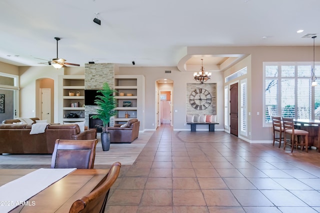 32731 N 74th Way, Scottsdale, AZ 85266 - living area with arched walkways, built in features, baseboards, a chandelier, and a ceiling fan