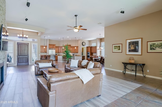 32731 N 74th Way, Scottsdale, AZ 85266 - living room featuring a chandelier, a ceiling fan, baseboards, a fireplace, and recessed lighting