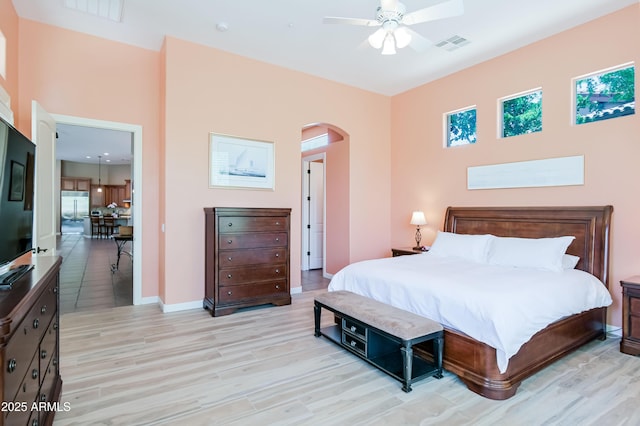 32731 N 74th Way, Scottsdale, AZ 85266 - bedroom featuring arched walkways, light wood finished floors, baseboards, and a ceiling fan