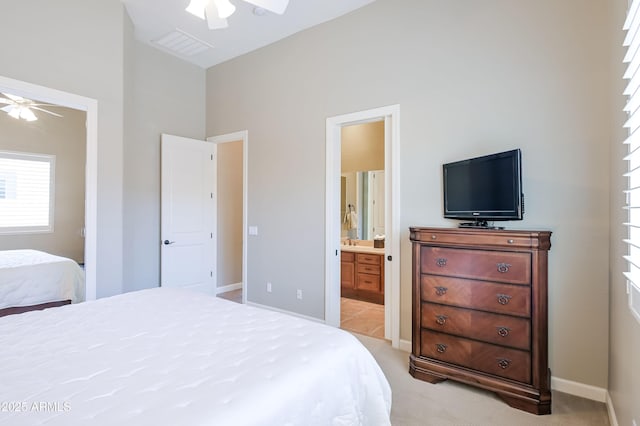 32731 N 74th Way, Scottsdale, AZ 85266 - bedroom featuring light colored carpet, connected bathroom, multiple windows, and a ceiling fan
