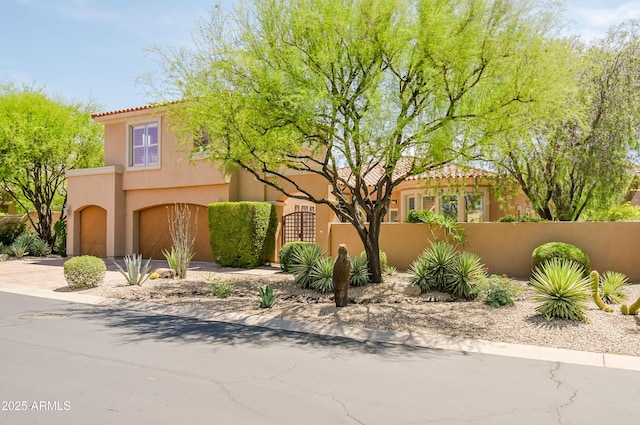 32731 N 74th Way, Scottsdale, AZ 85266 - mediterranean / spanish house with a garage, a fenced front yard, driveway, stucco siding, and a gate
