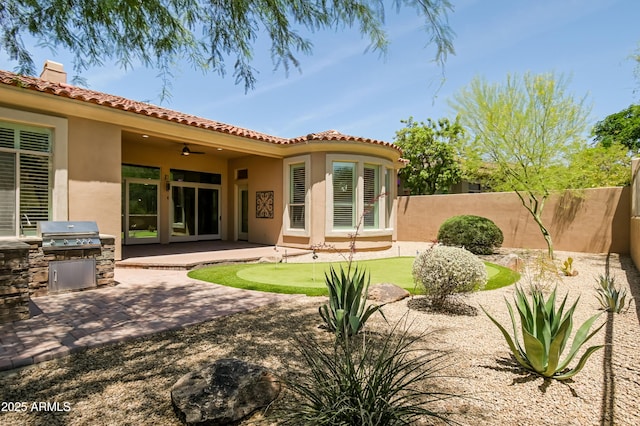 32731 N 74th Way, Scottsdale, AZ 85266 - back of property with an area to practice putting, stucco siding, area for grilling, a patio area, and a tile roof