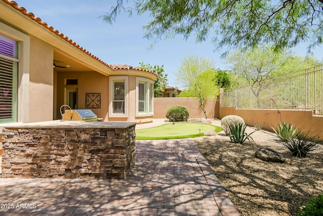 32731 N 74th Way, Scottsdale, AZ 85266 - fenced backyard with a putting green, a patio, and exterior kitchen