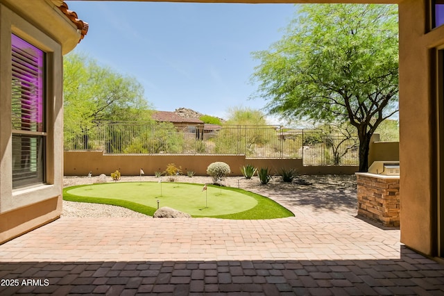 32731 N 74th Way, Scottsdale, AZ 85266 - fenced backyard with a putting green, a patio, and exterior kitchen