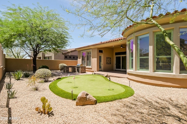 32731 N 74th Way, Scottsdale, AZ 85266 - back of house featuring an area to practice putting, stucco siding, a patio, a tile roof, and a ceiling fan