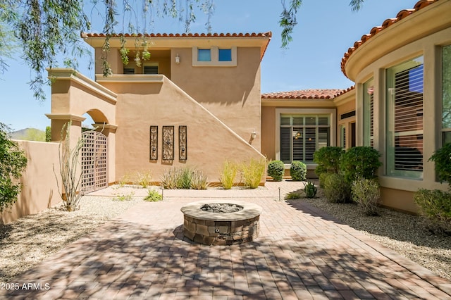 32731 N 74th Way, Scottsdale, AZ 85266 - rear view of property with a patio, an outdoor fire pit, stucco siding, and a tiled roof