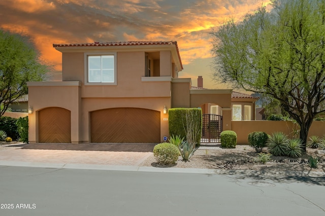 32731 N 74th Way, Scottsdale, AZ 85266 - mediterranean / spanish-style house featuring a tiled roof, stucco siding, an attached garage, a gate, and driveway