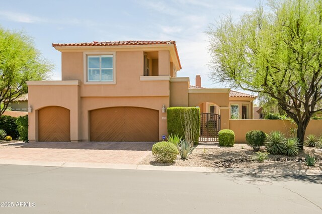32731 N 74th Way, Scottsdale, AZ 85266 - mediterranean / spanish home featuring stucco siding, a tile roof, a garage, a gate, and decorative driveway