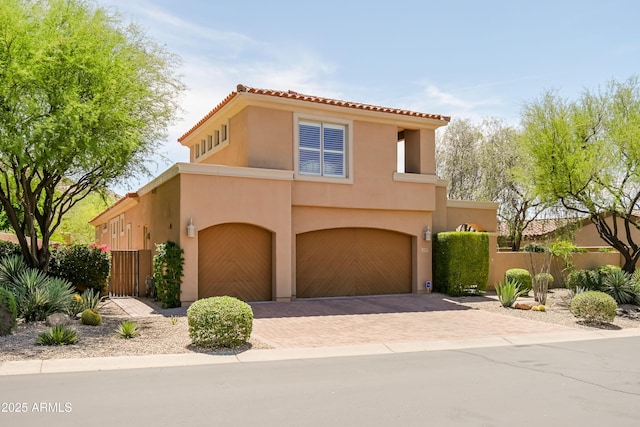 32731 N 74th Way, Scottsdale, AZ 85266 - mediterranean / spanish home featuring an attached garage, decorative driveway, stucco siding, and a tile roof