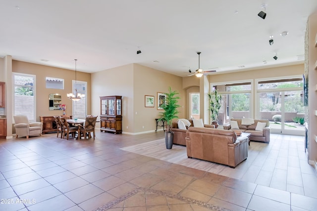 32731 N 74th Way, Scottsdale, AZ 85266 - living area featuring a chandelier, light tile patterned floors, a ceiling fan, and baseboards