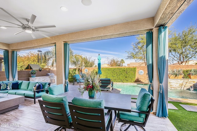 sunroom / solarium featuring ceiling fan