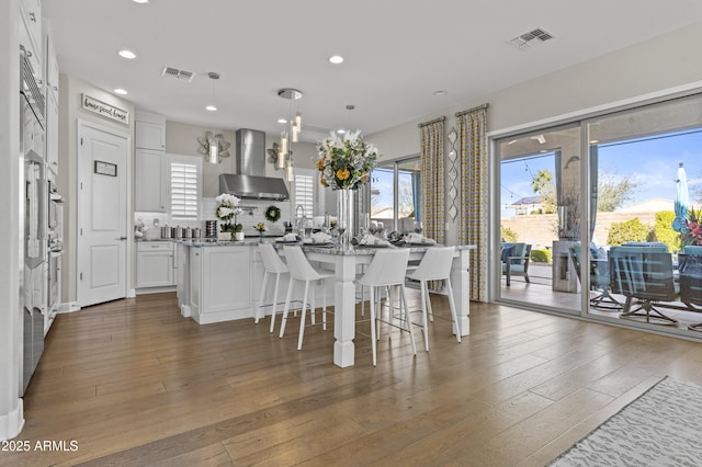 dining area with a healthy amount of sunlight and dark hardwood / wood-style flooring