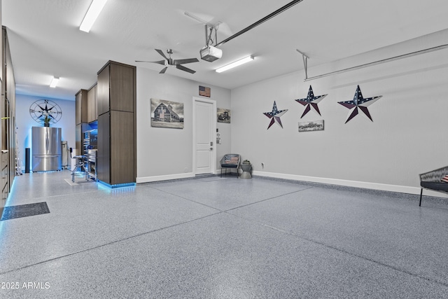 garage with stainless steel refrigerator and a garage door opener