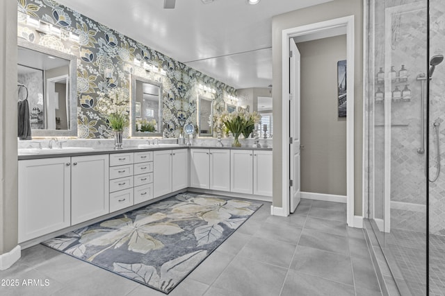 bathroom featuring a tile shower, vanity, and tile patterned flooring