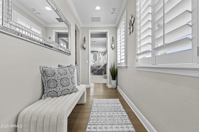 corridor featuring crown molding, plenty of natural light, and dark hardwood / wood-style flooring