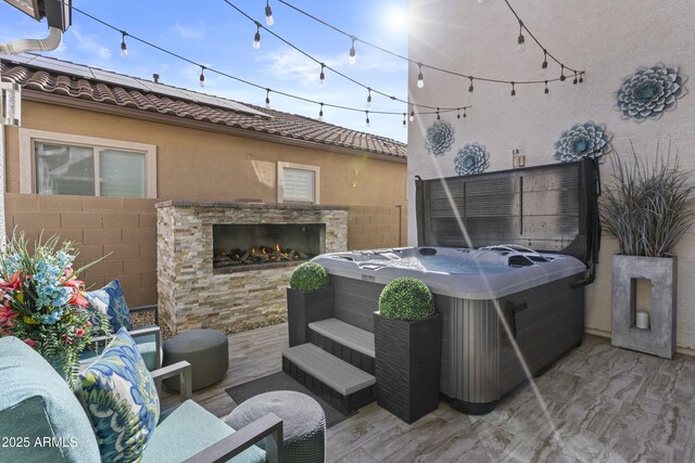 view of patio featuring an outdoor stone fireplace