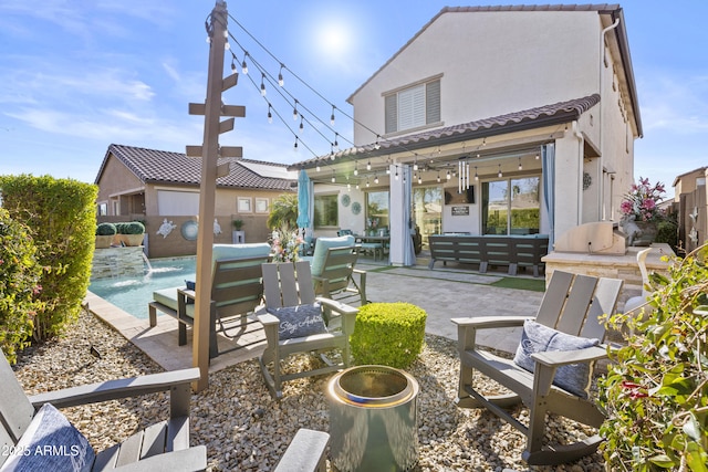 rear view of property featuring a fenced in pool, a patio, area for grilling, pool water feature, and an outdoor living space