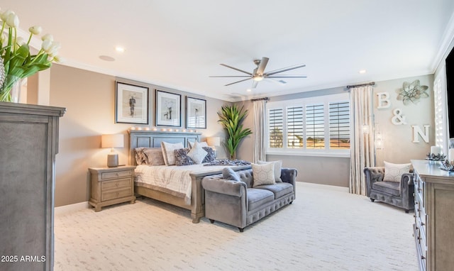 carpeted bedroom featuring ceiling fan and ornamental molding