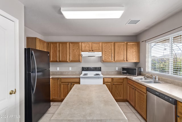 kitchen featuring appliances with stainless steel finishes, light tile patterned floors, and sink